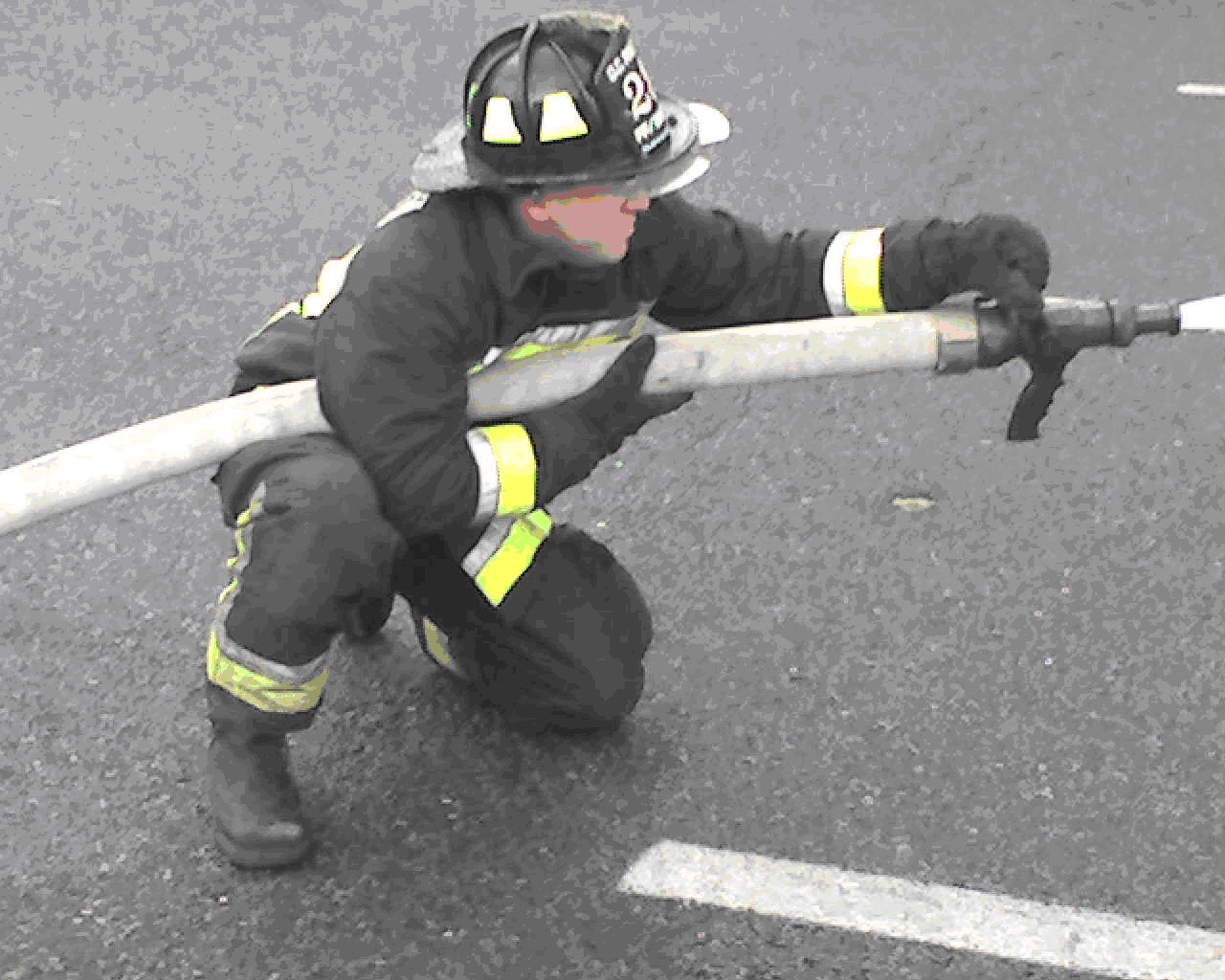 Single firefighter/hose locked between arm and leg